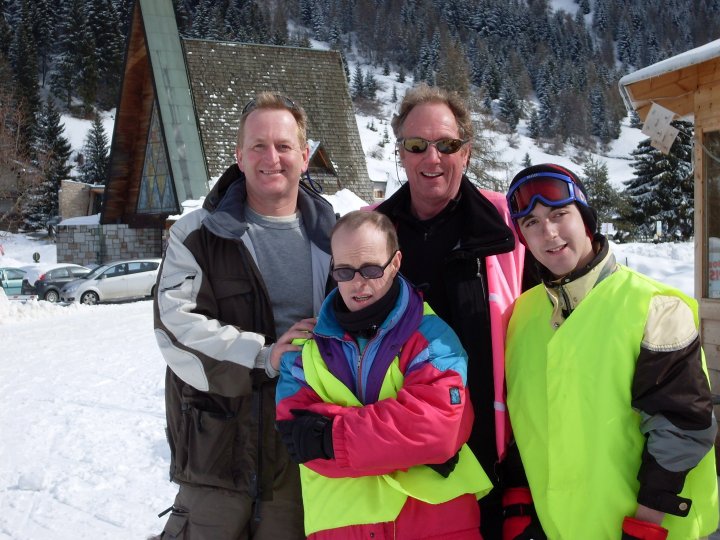 Group of skiers in the snow looking happy.